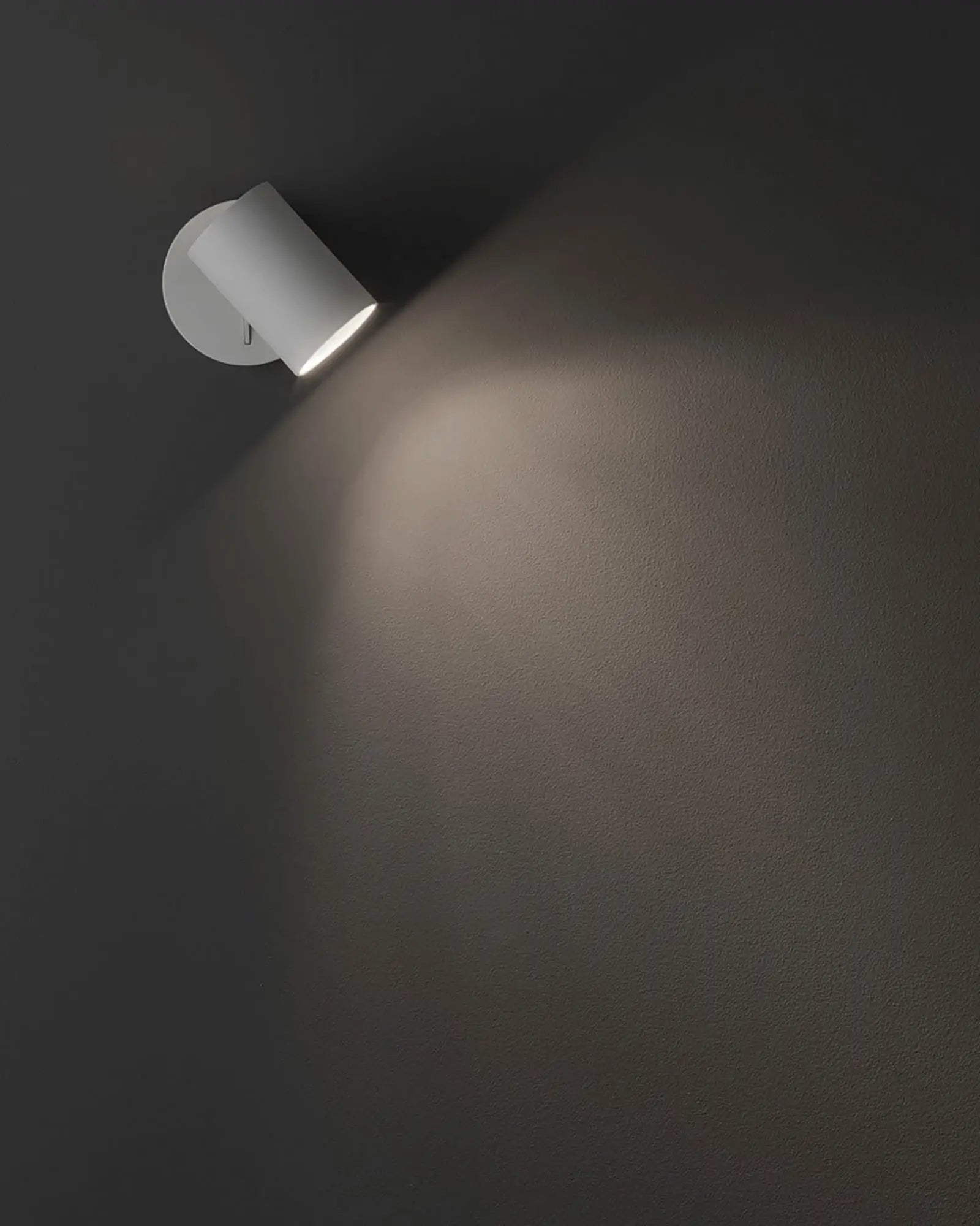 Ascoli switched adjustable wall light on a black wall