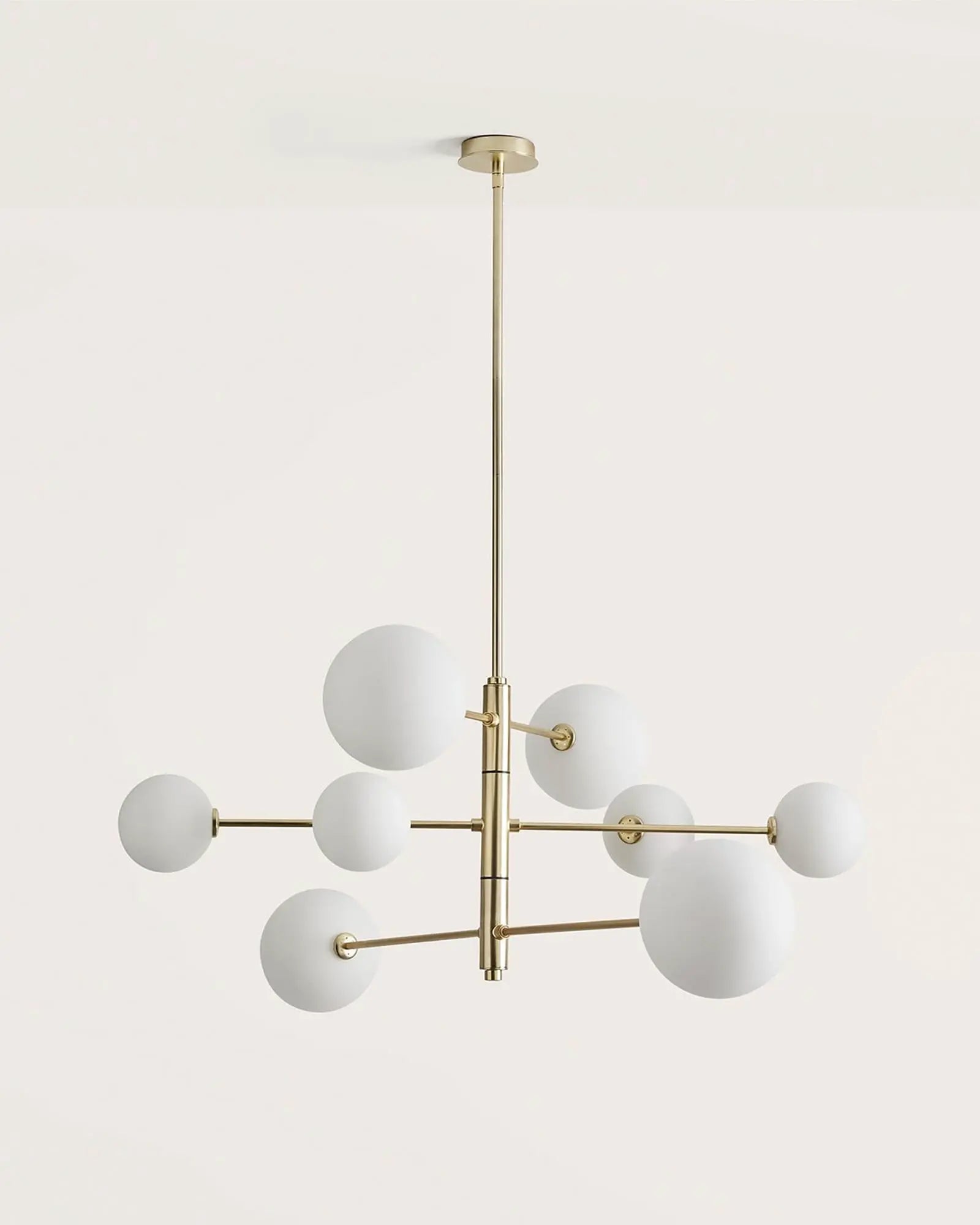 Atom contemporary adjustable pendant light in brass and opal glass orb shades 