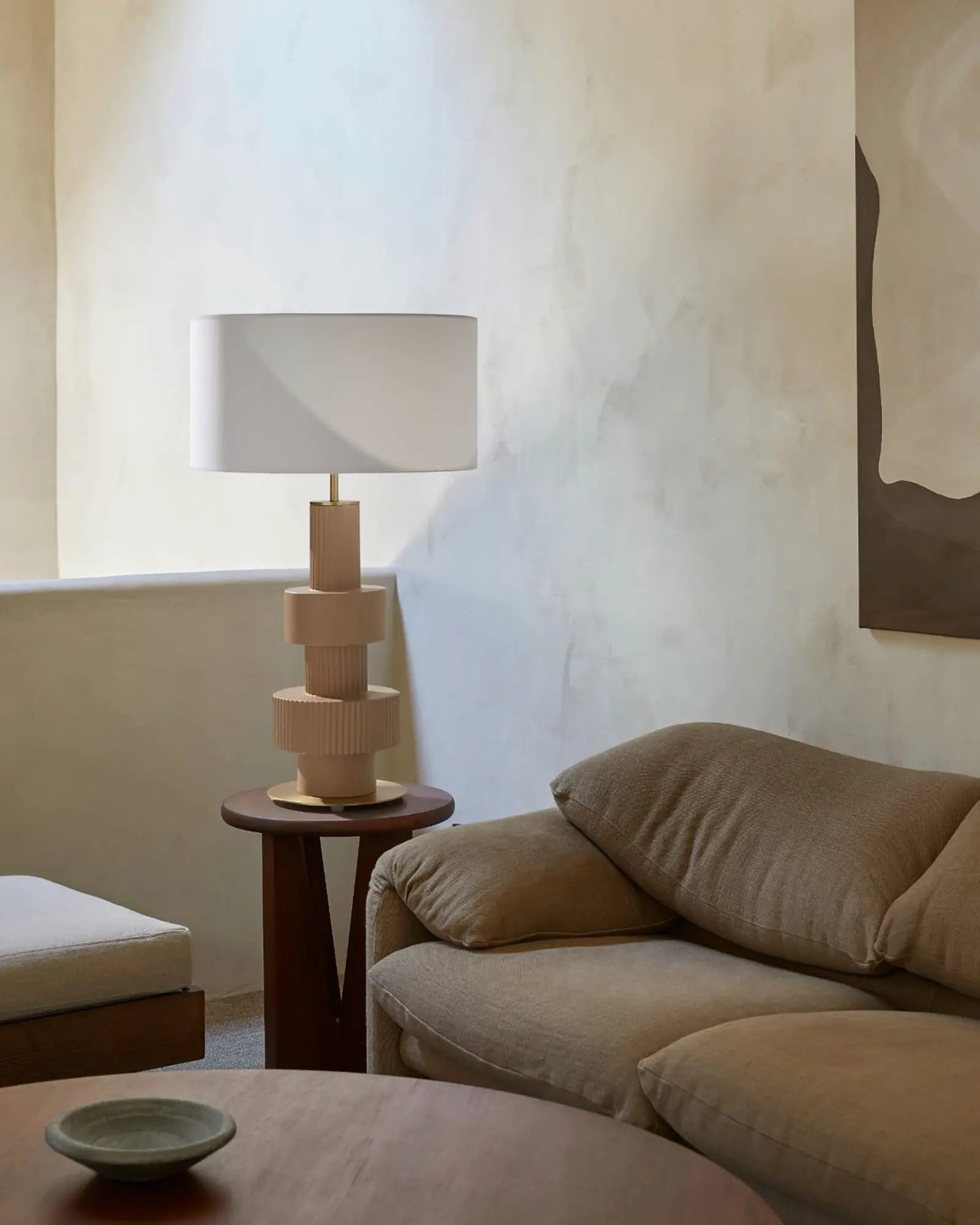 Babel ceramic contemporary table lamp with fabric shadenear a sofa in livingroom