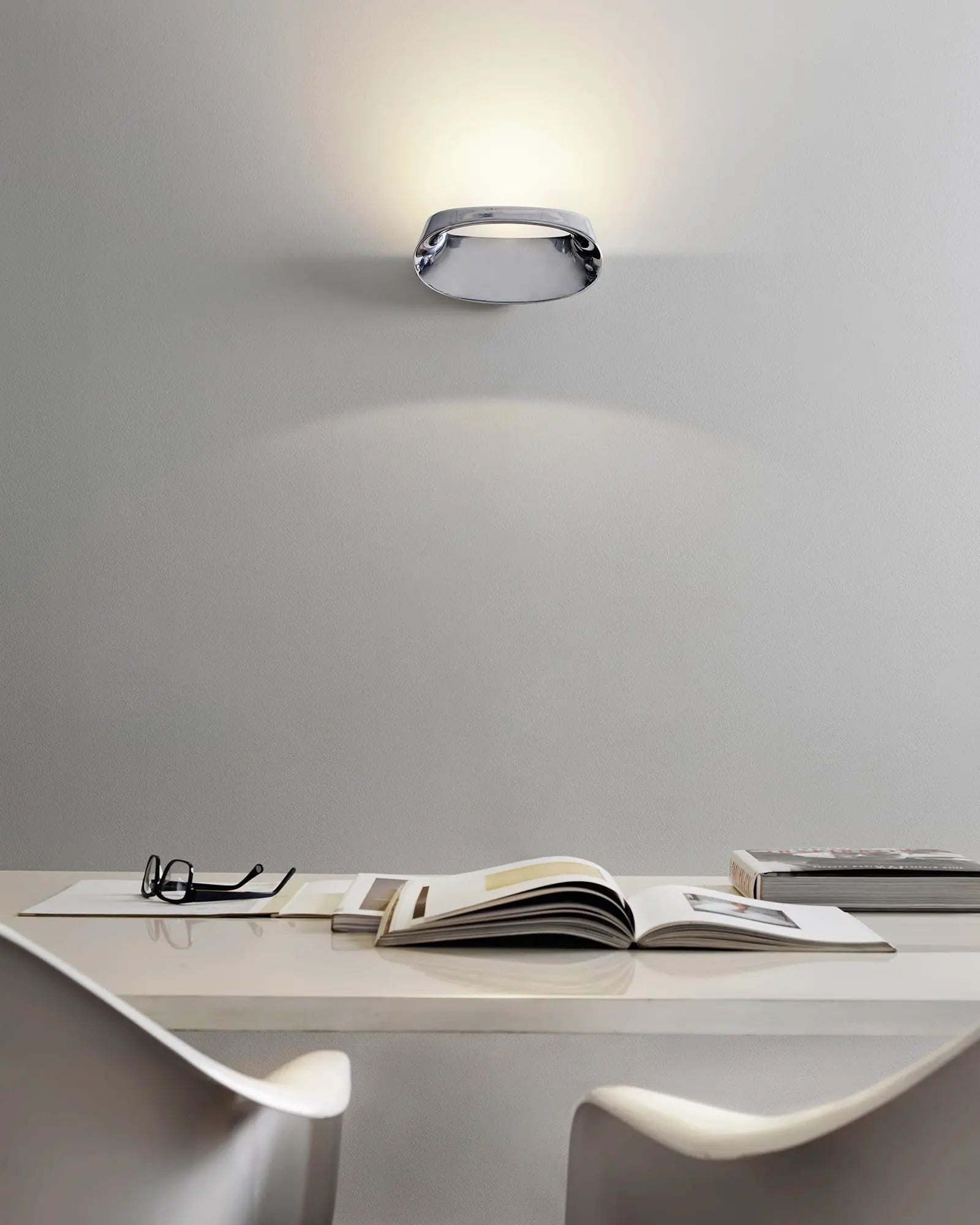 Bonnet contemporary wall light above a desk