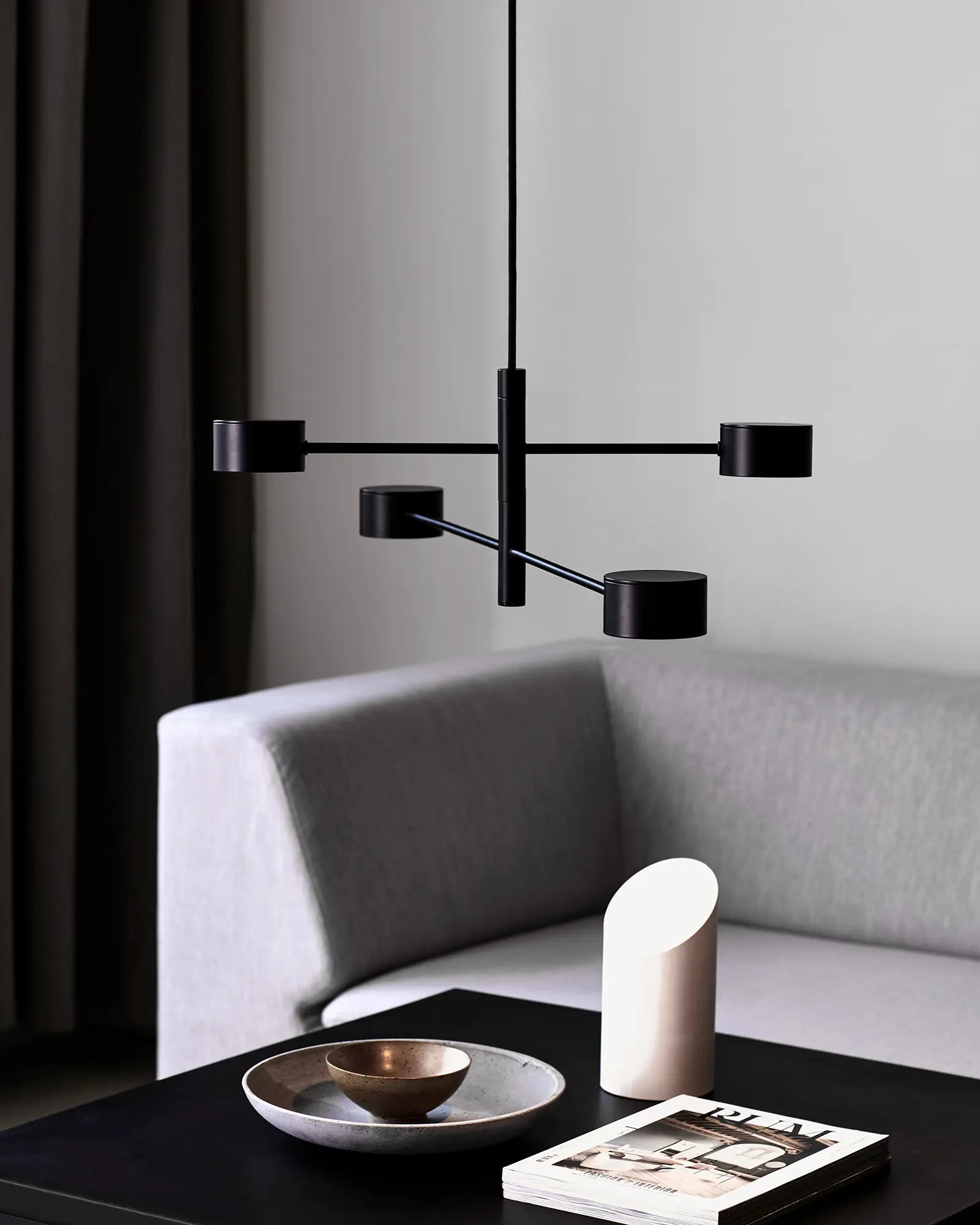 adjustable Scandinavian pendant light above coffee table