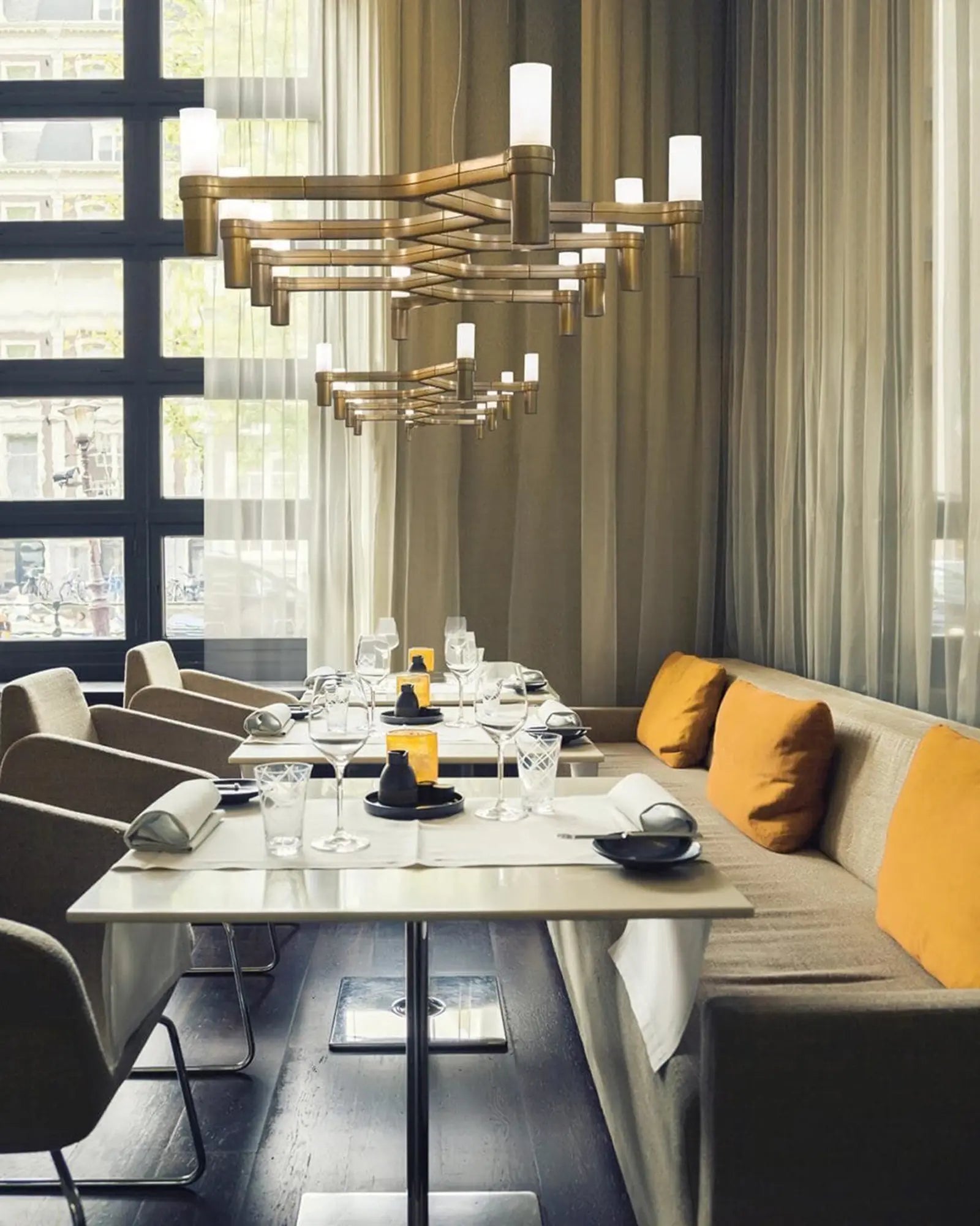 Crown plana long horizontal pendant light  cluster above dining tables in a restaurant