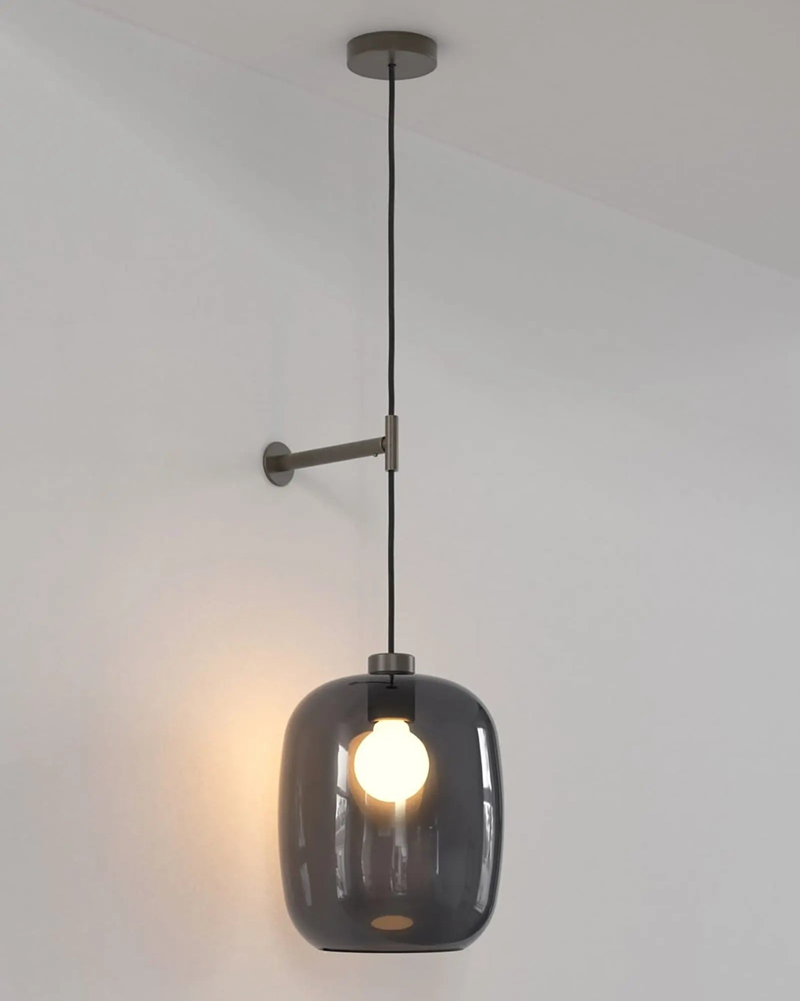 Curve contemporary pendant light with wall mount and smoke blown glass shade bronze large