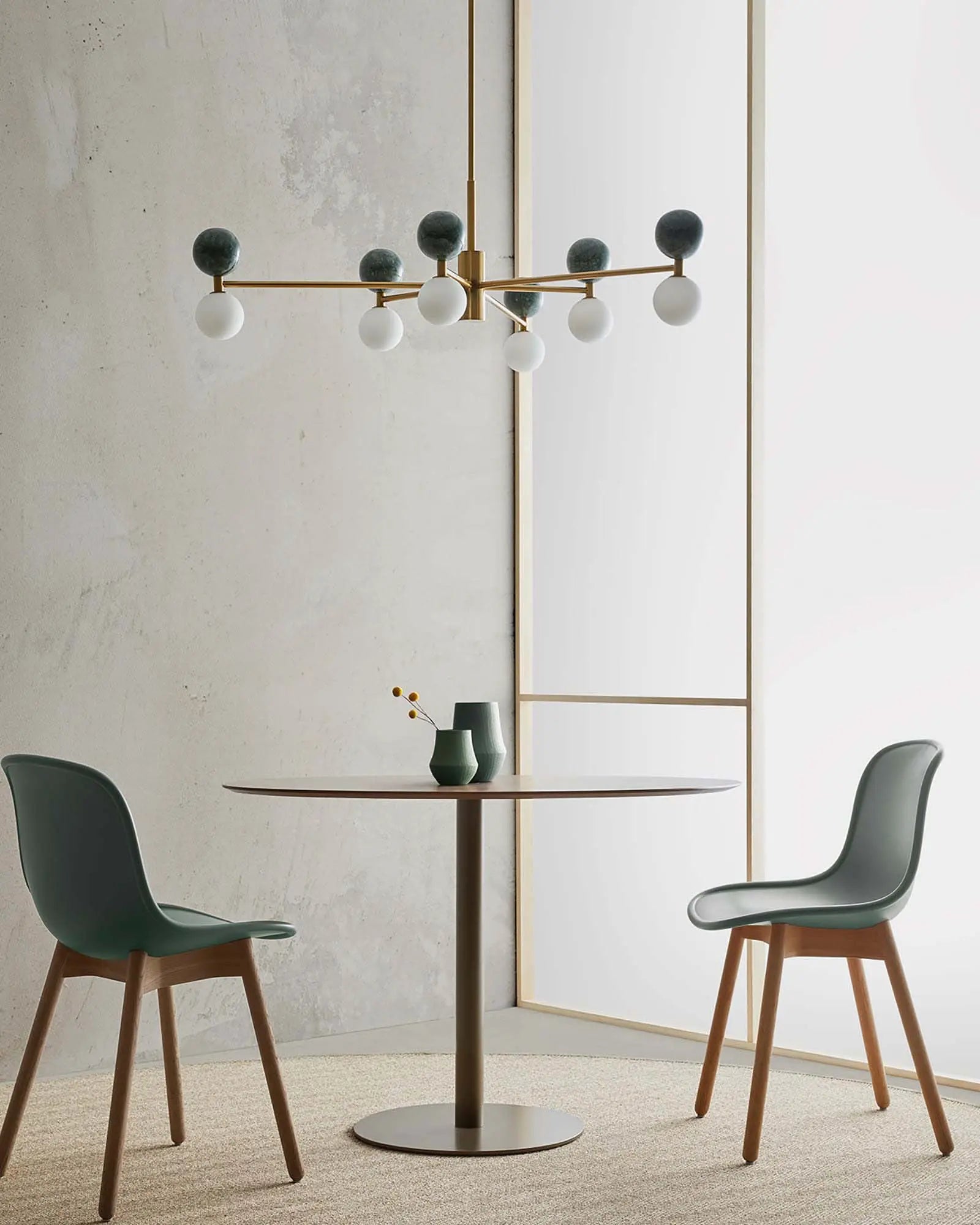 Dalt 6 pendant light marble and opal spheres in brass above a round table