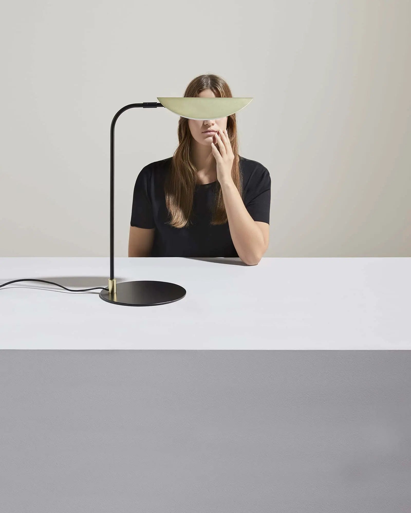Ficus contemporary minimal table lamp with brass shade on a bench