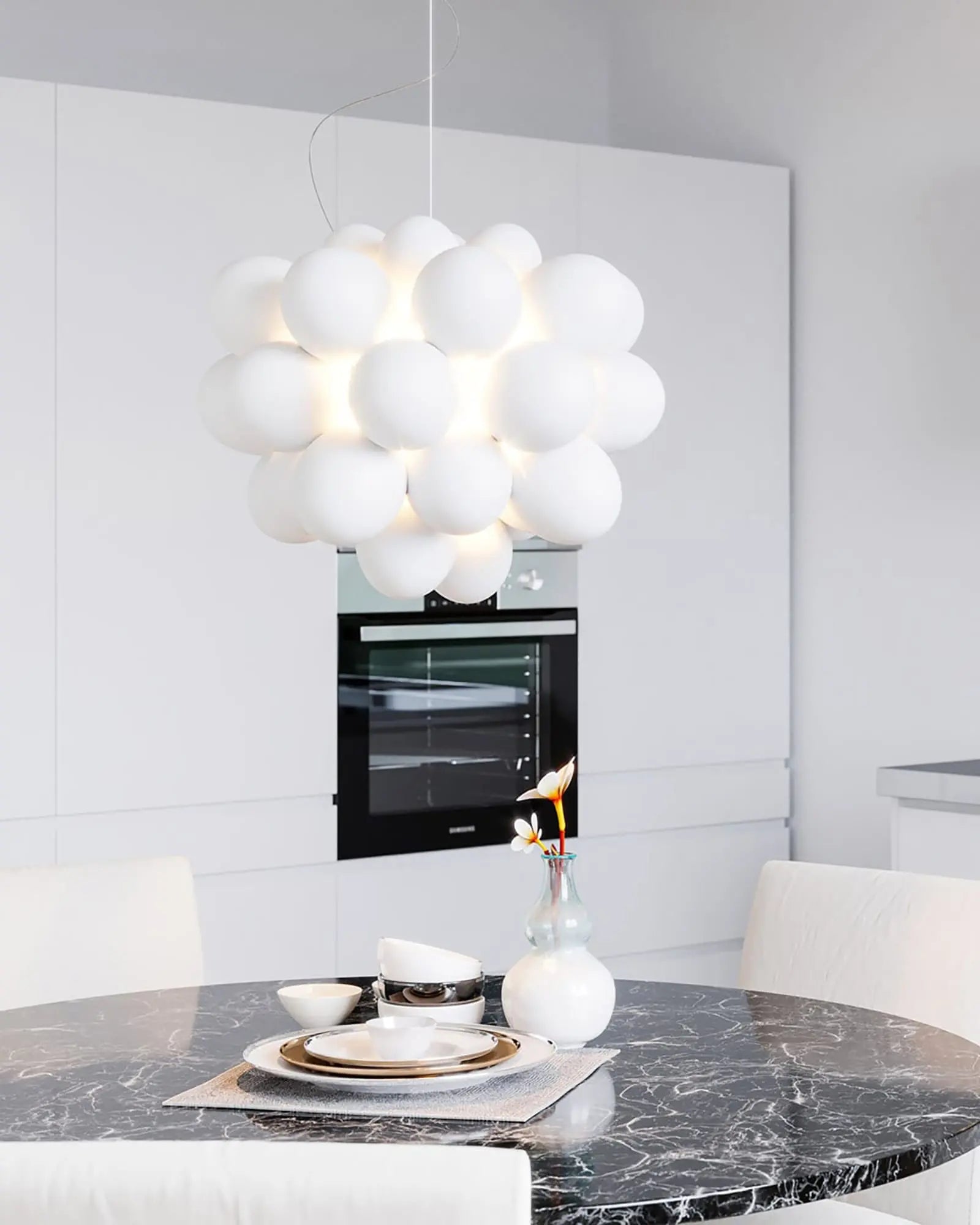 Gross blown glass pendant light above a dining table