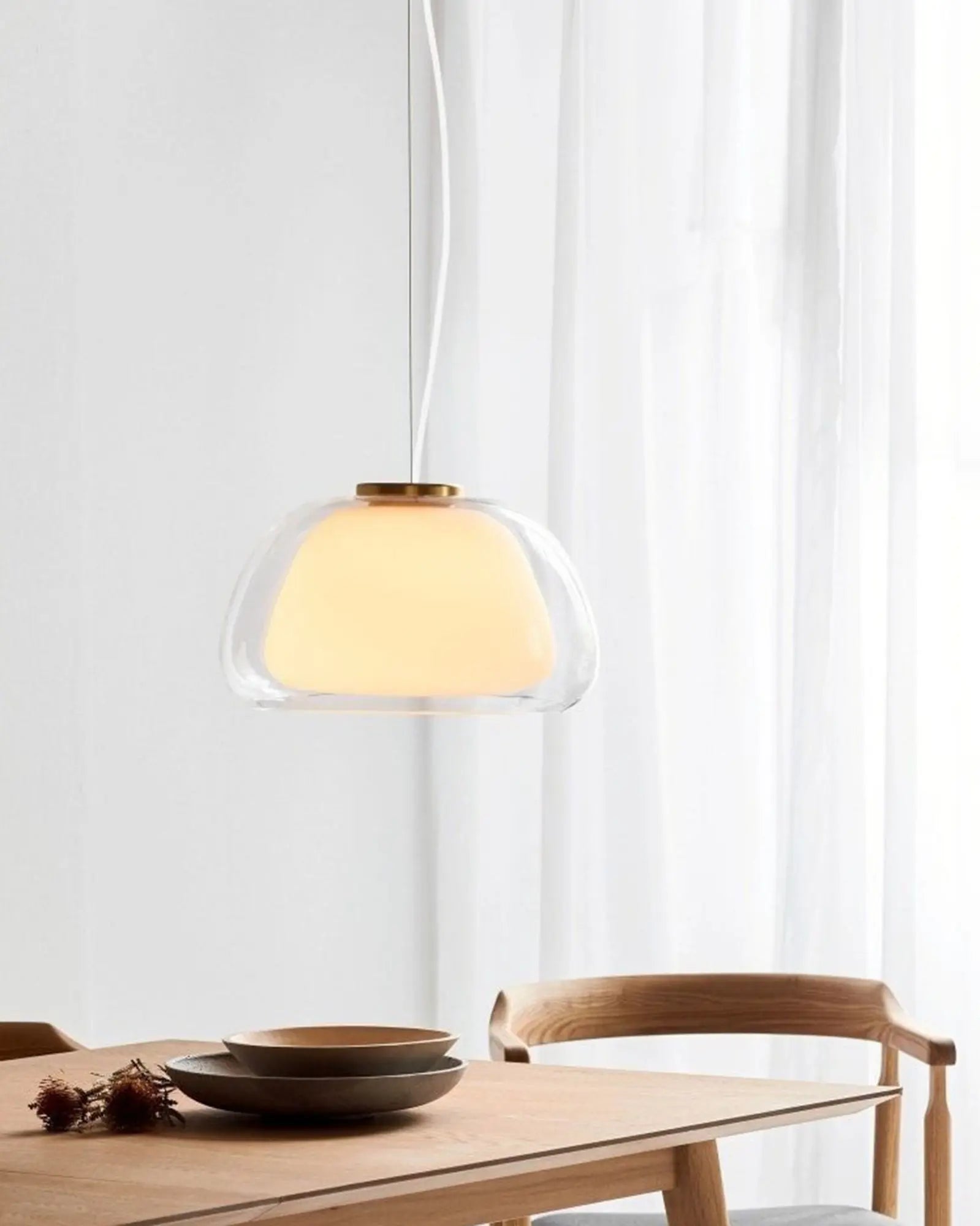 Jelly double glass pendant light above a dining table 