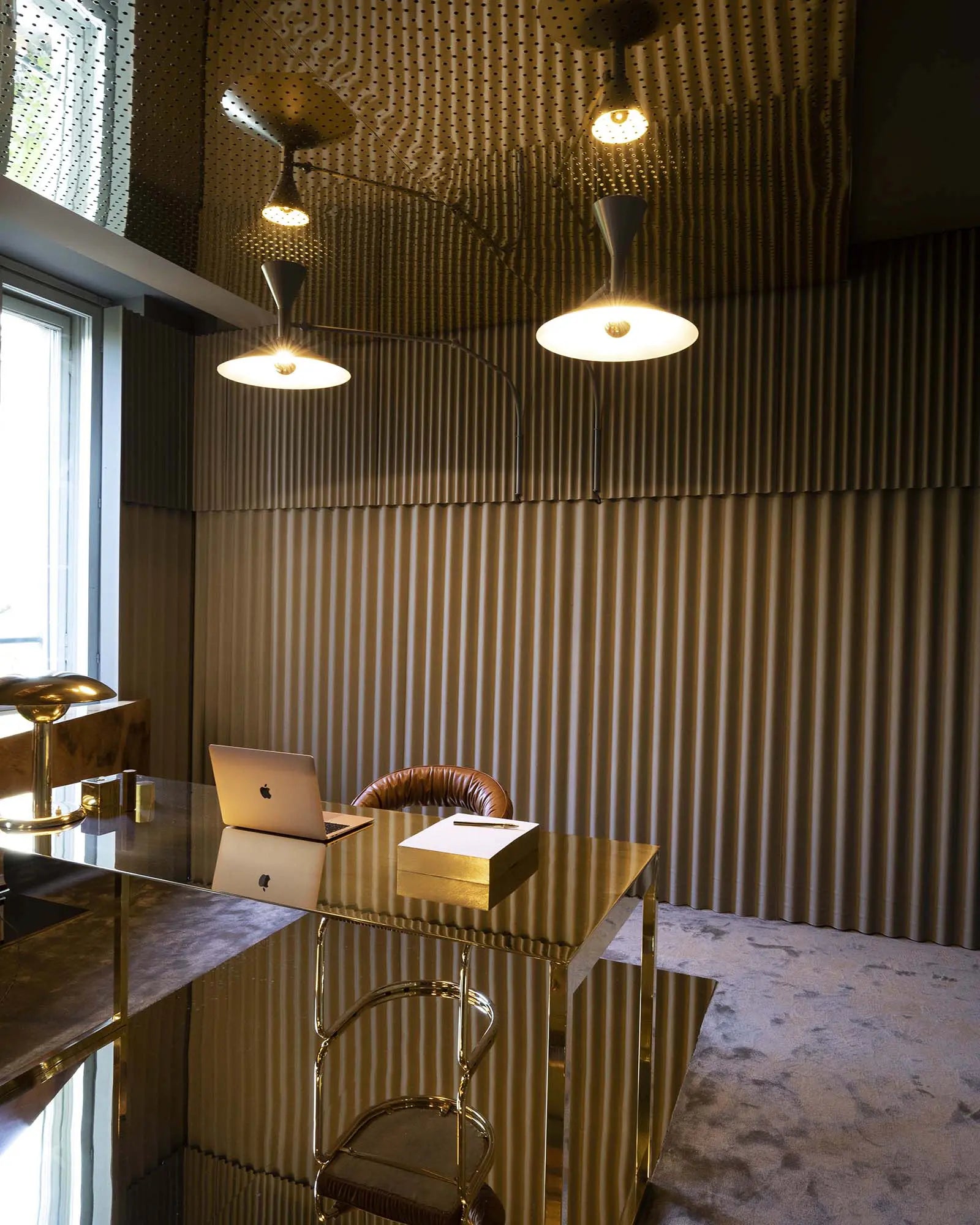 Lamp de Marseille iconic adjustable modern wall light in a studio above a desk