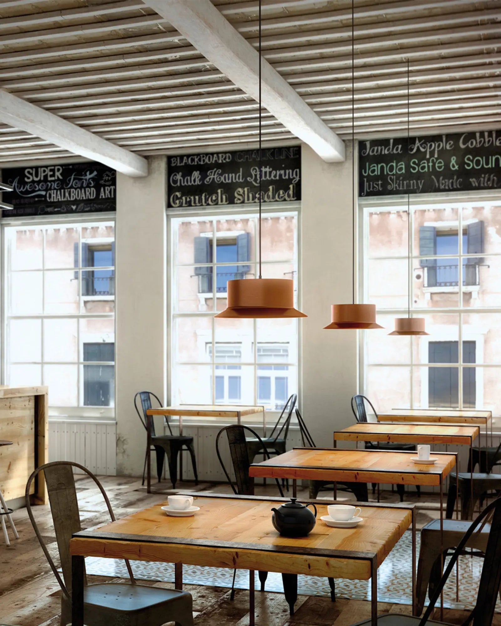 Maine pendant light by Estiluz lighting above dining tables within a restaurant
