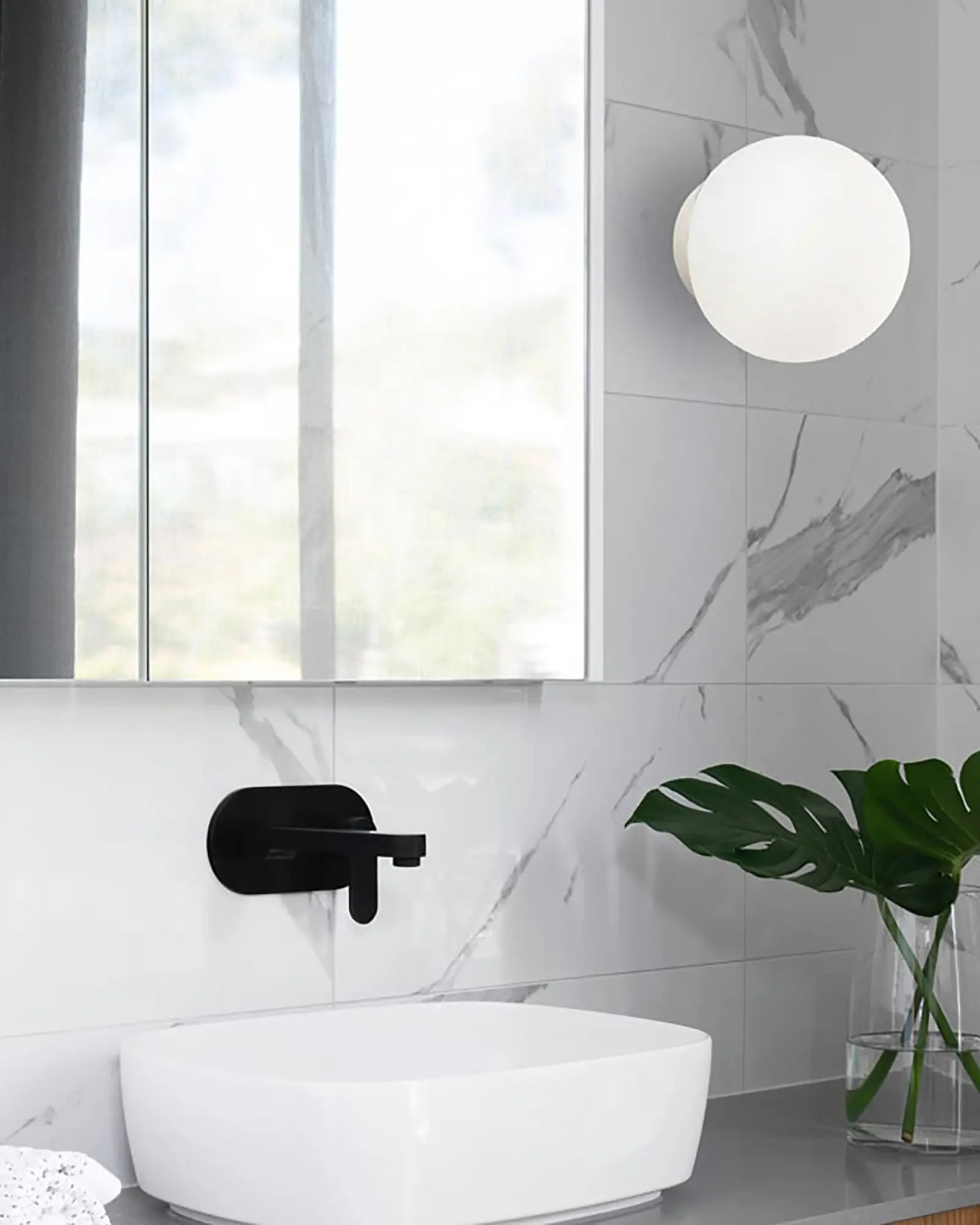 Mapa orb wall light in a bathroom on the mirror side