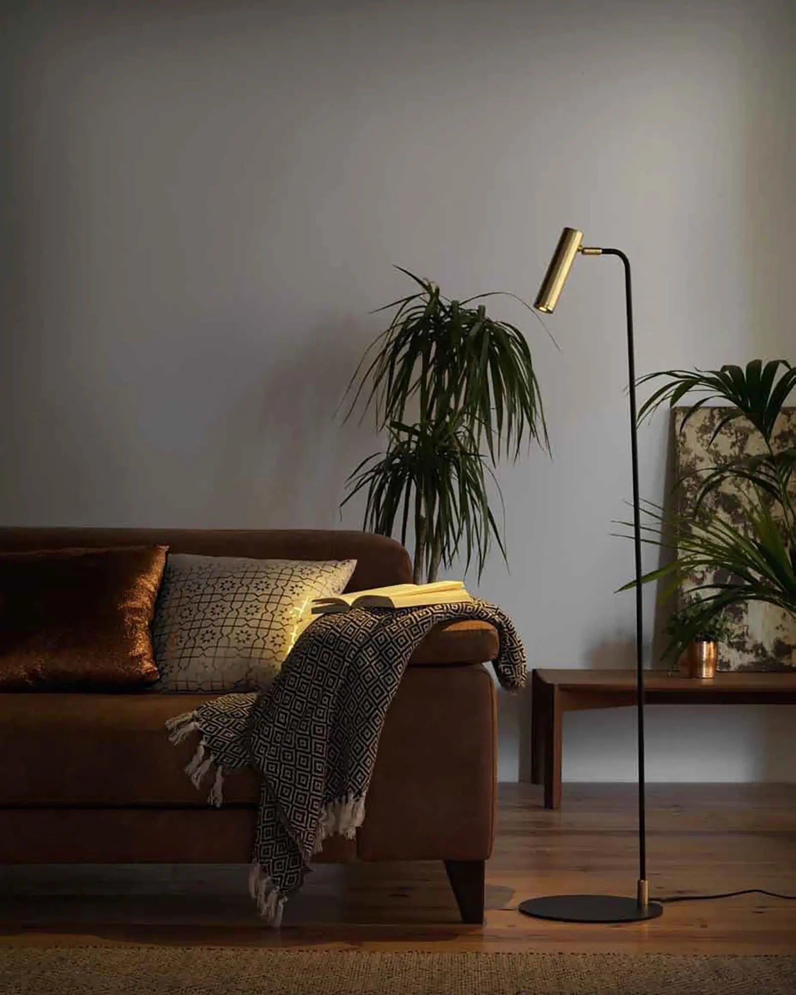Maru spot reading floor lamp beside a sofa