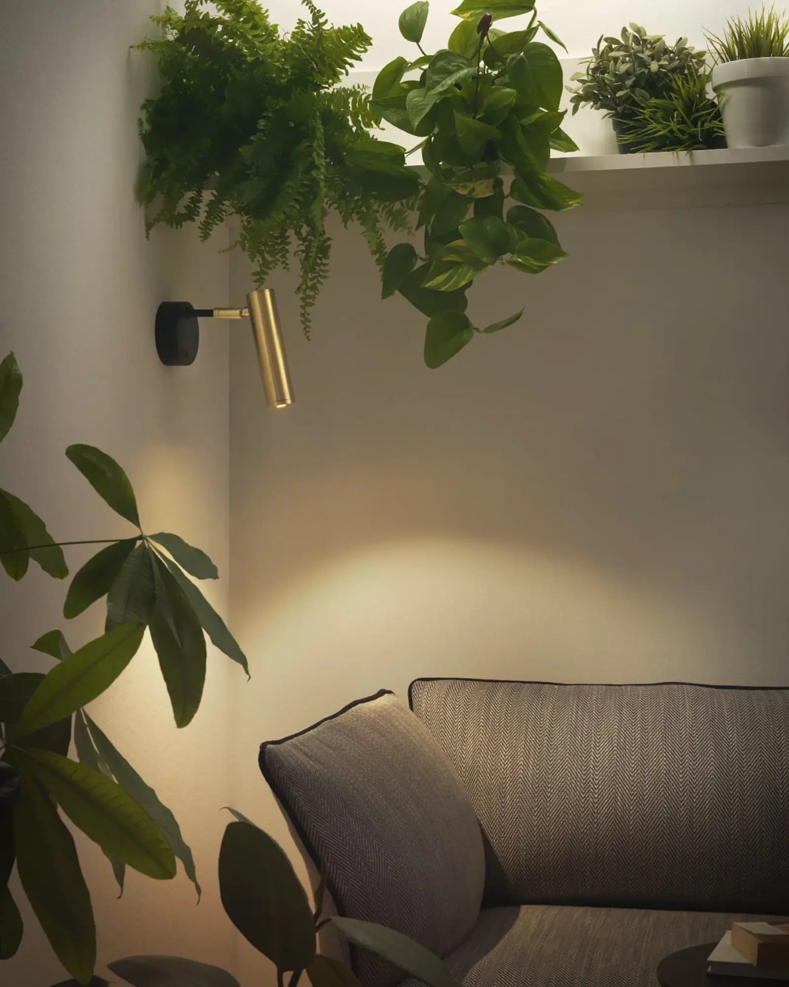 Maru adjustable minimal spot wall light near a sofa