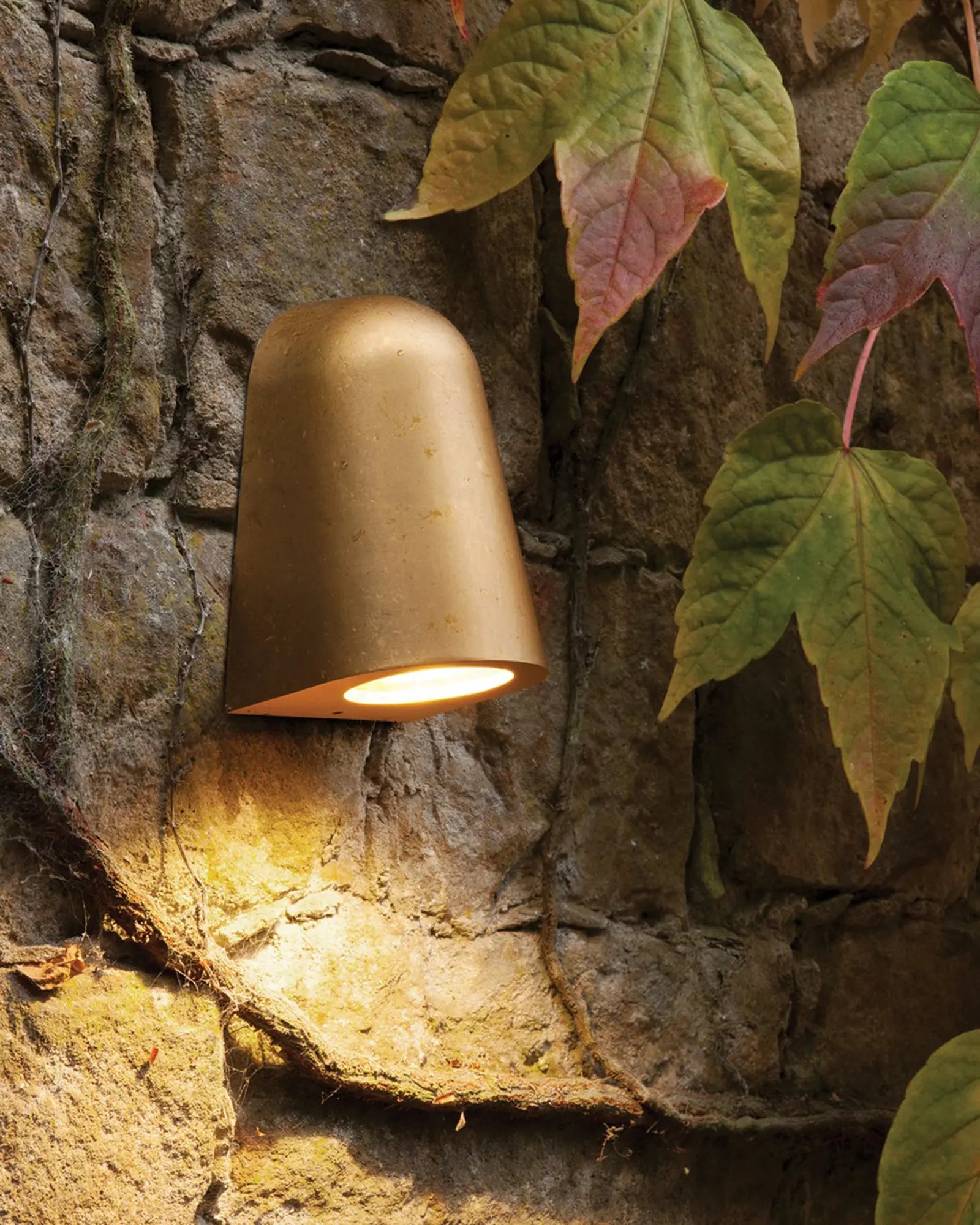 Mast minimal outdoor wall light brass on rock wall
