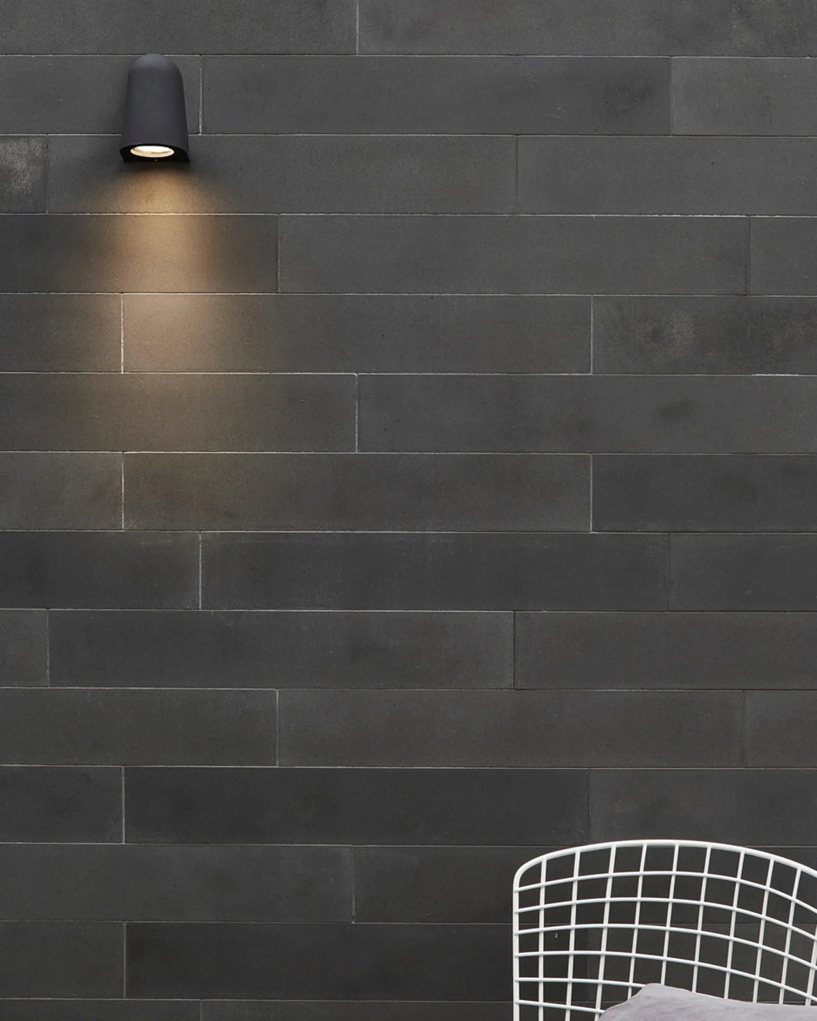 Mast minimal outdoor wall light on exterior black tiles