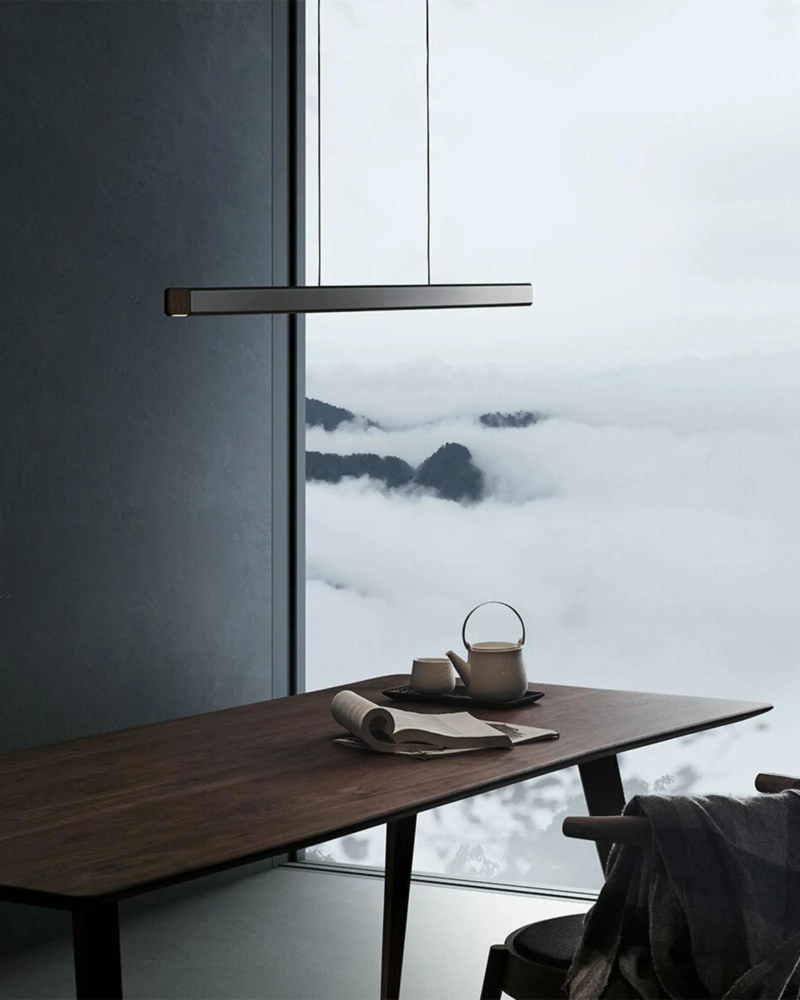 Mumu modern linear pendant light above a table