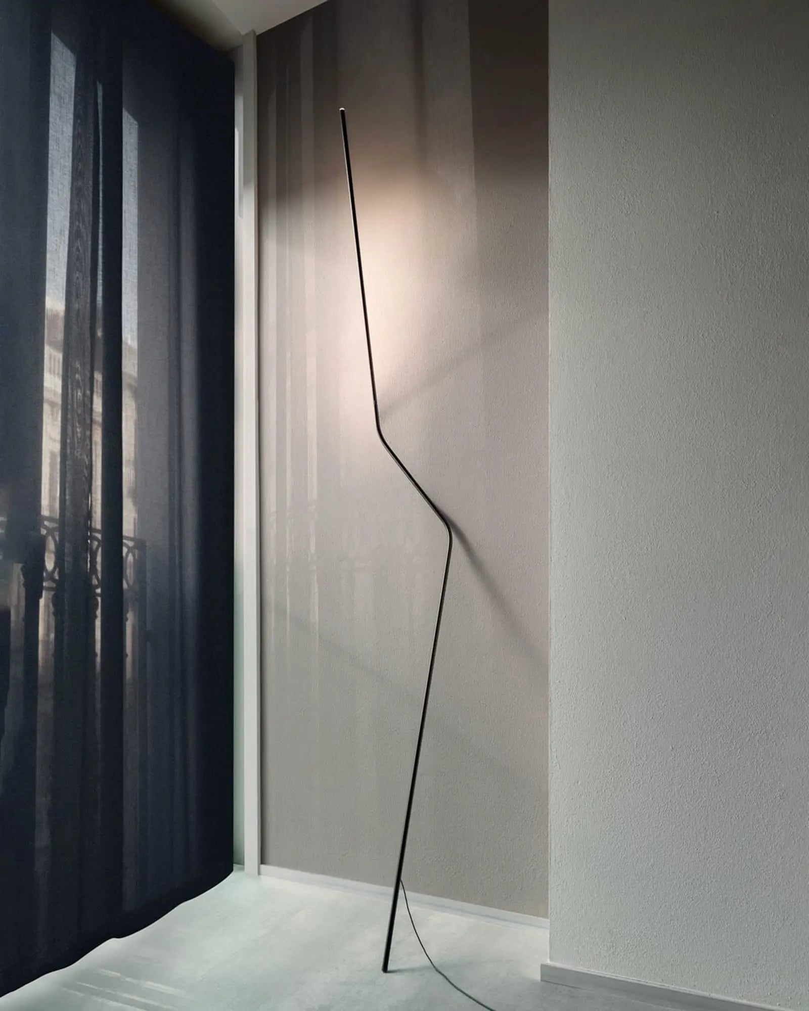 Neo modern LED floor lamp on a wall