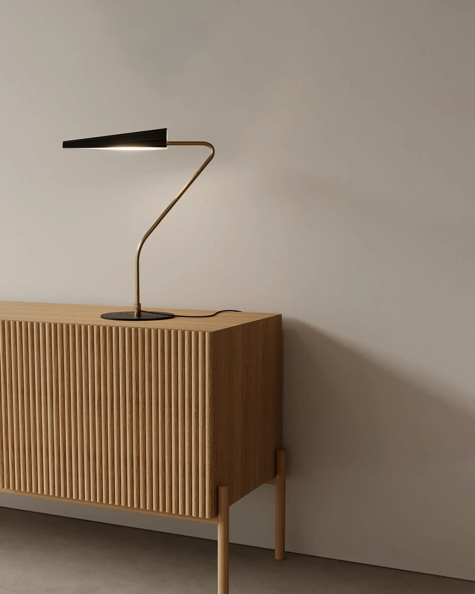 Bion contemporary table lamp on wooden cabinet