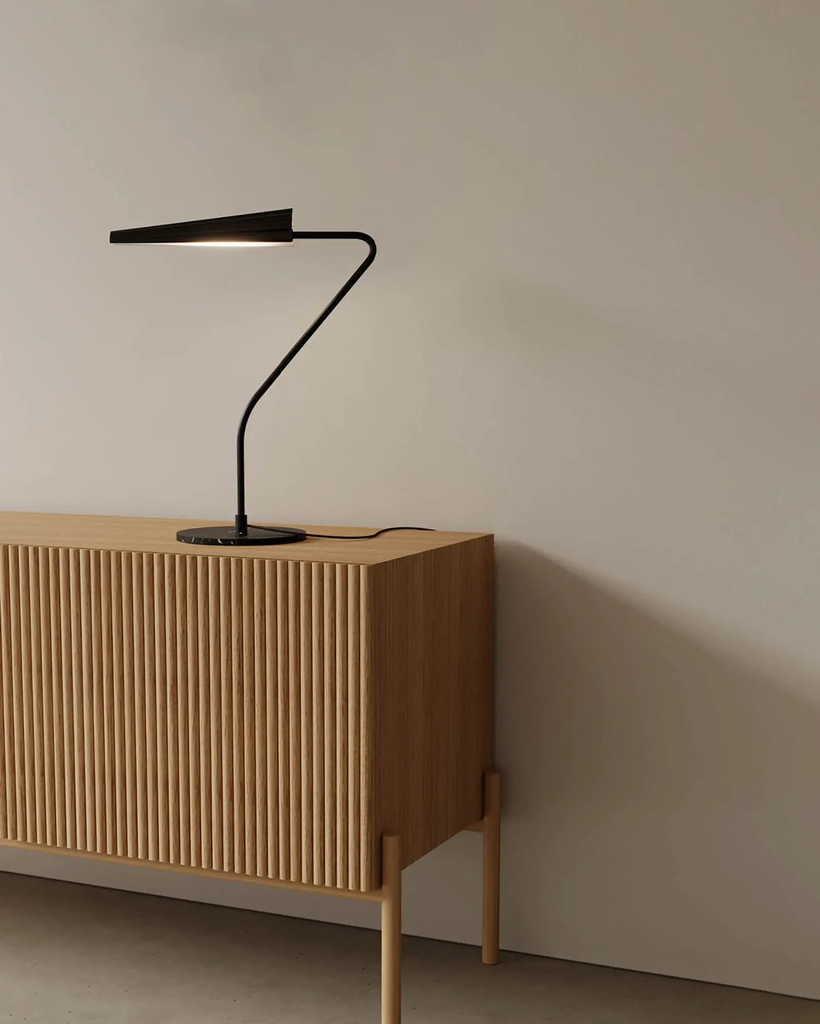 Bion contemporary table lamp on wooden cabinet