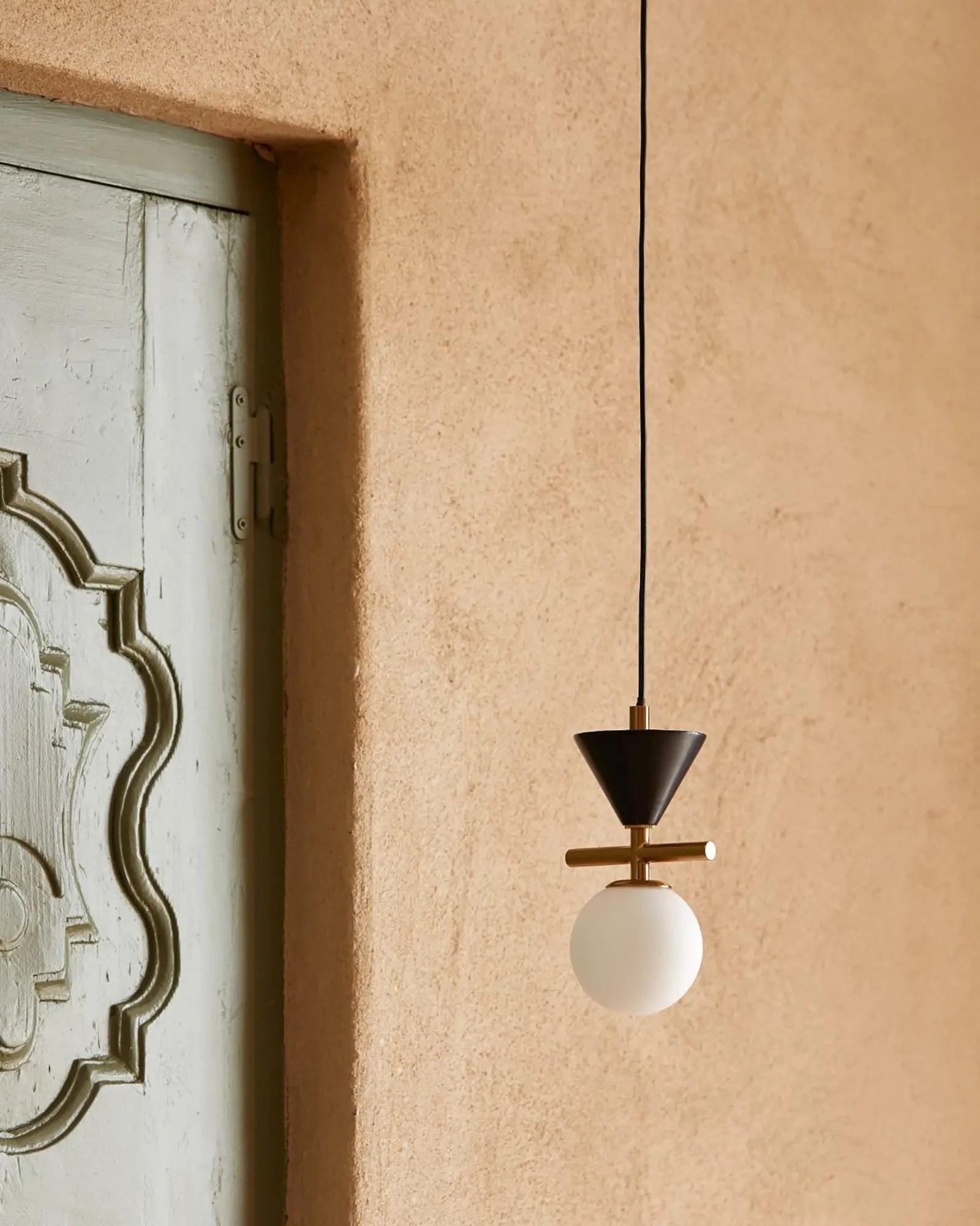Oneta contemporary single pendant with opal glass orb shade near entry door