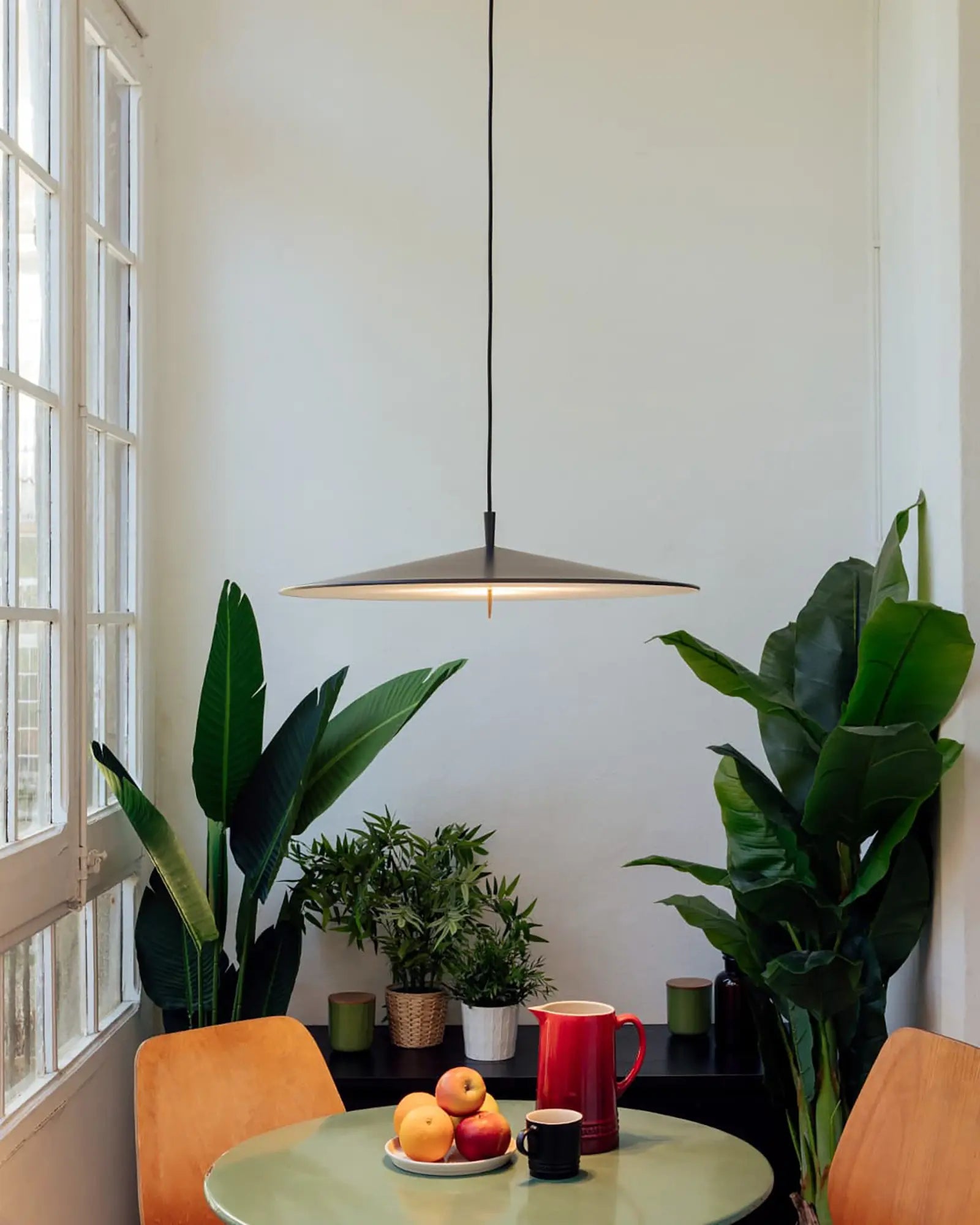 Pla modern flat dome pendant light above a dining table