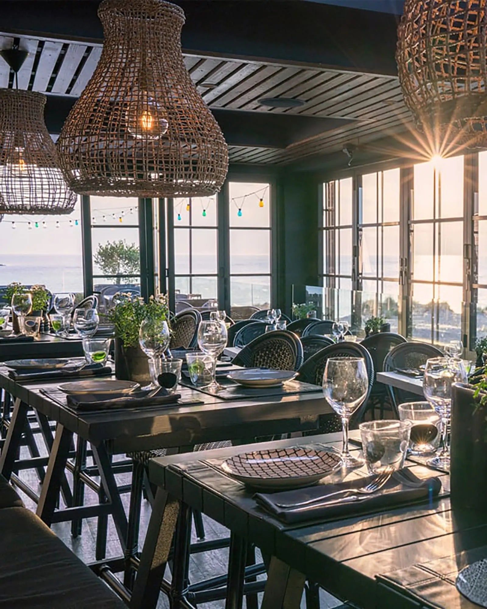 Seagrass organic pendant light above tables in a restaurant