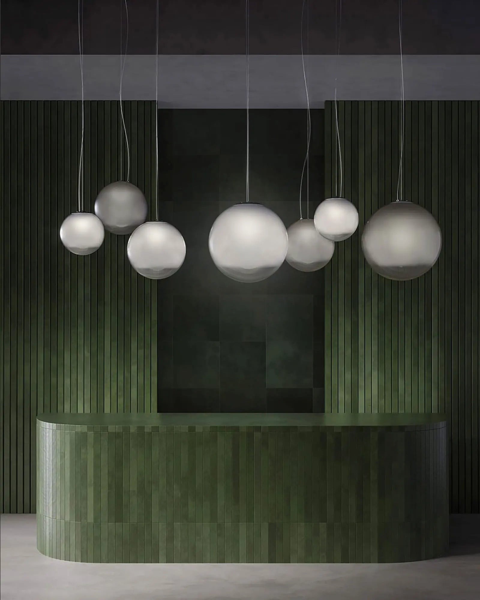 Smoke blown glass pendant light cluster above reception