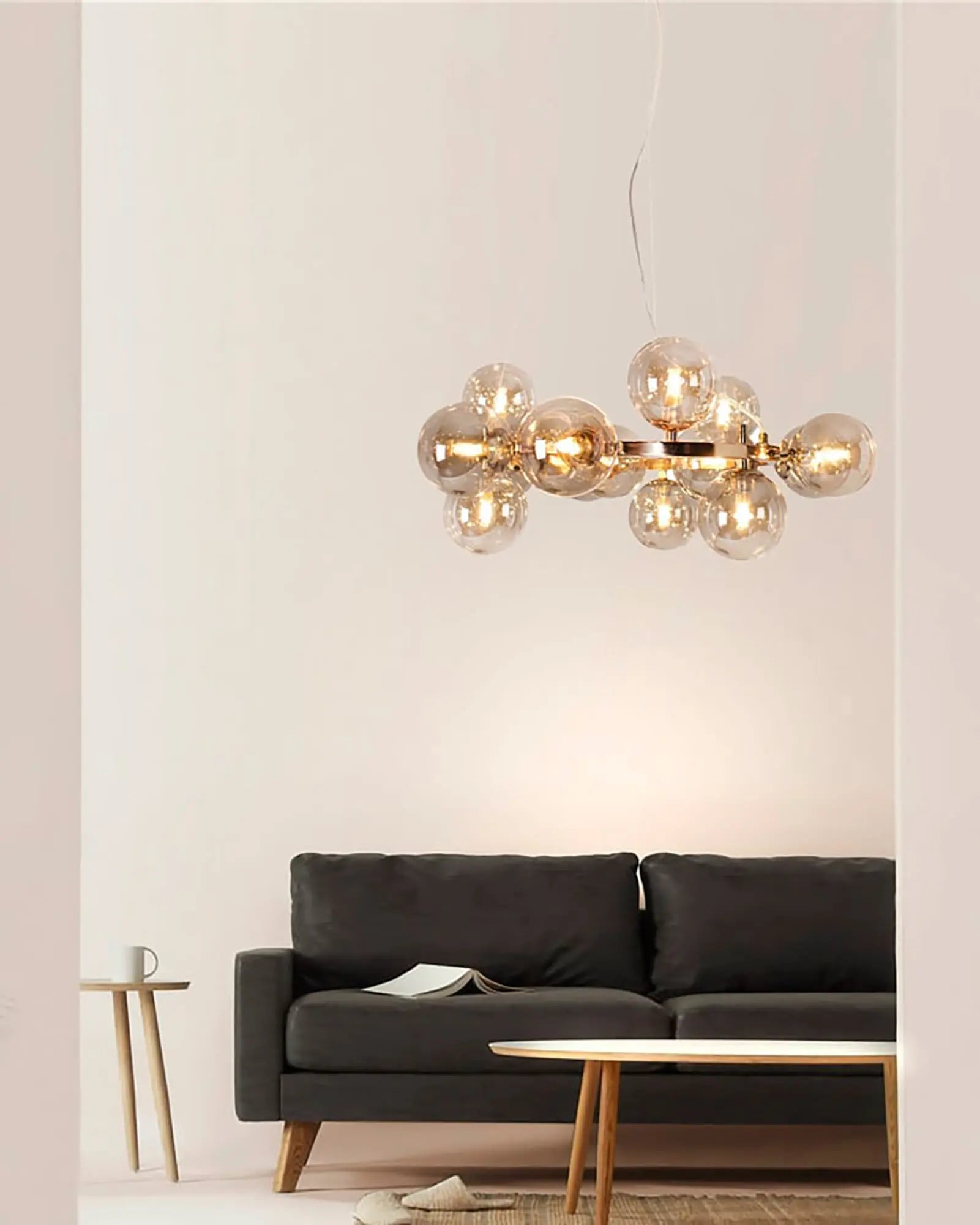 Splendor blown glass and brass modern pendant light above a coffee table