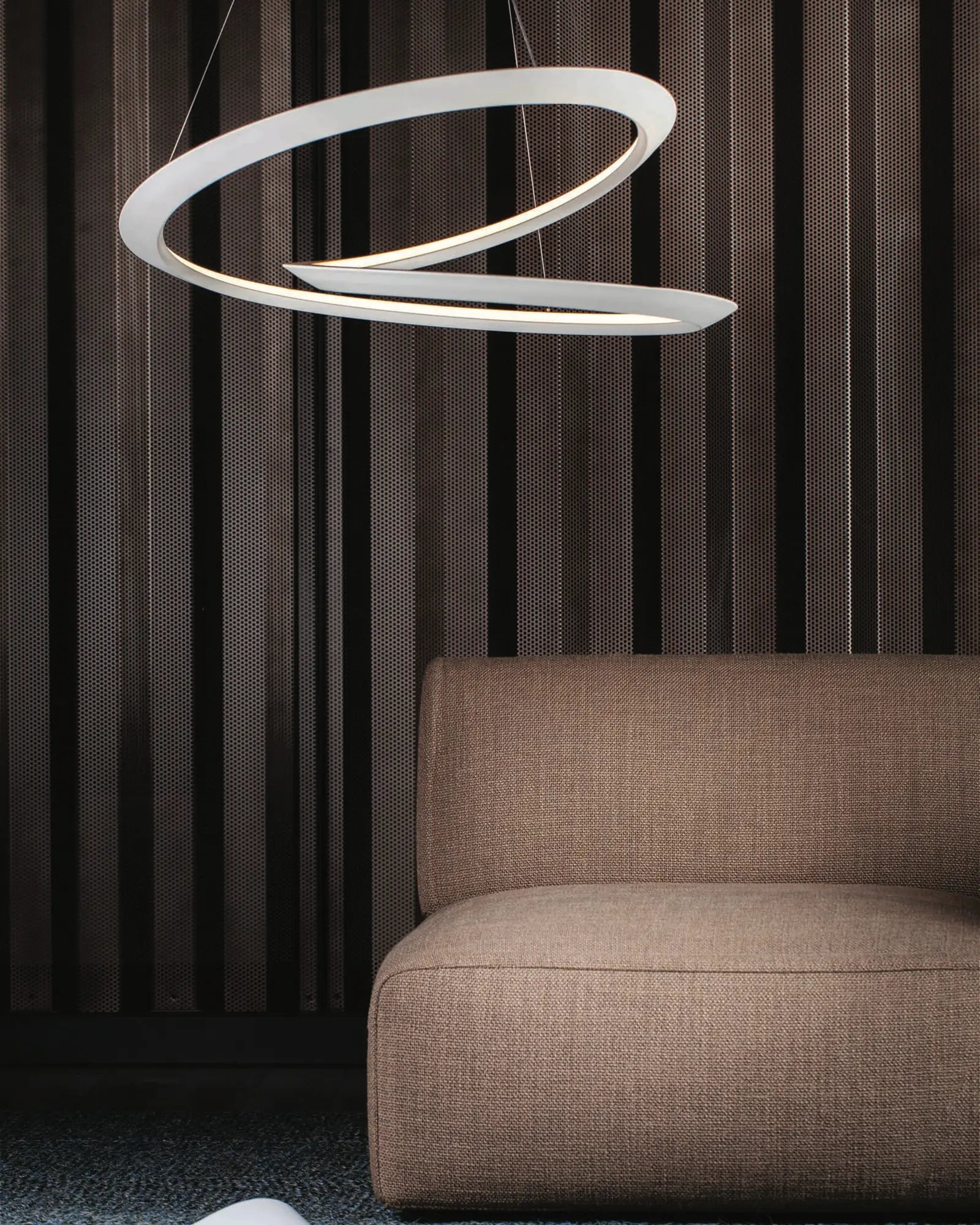 Kepler contemporary LED pendant light above a sofa
